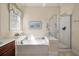 Bright bathroom featuring a soaking tub with jets and a separate glass-enclosed shower at 1781 Tennyson # 6, Mount Pleasant, SC 29466