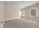 A bedroom features neutral walls, plush carpet, and two windows offering ample natural light at 1781 Tennyson # 6, Mount Pleasant, SC 29466