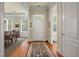 Welcoming entryway with hardwood floors, elegant rug, and access to dining area and powder room at 1781 Tennyson # 6, Mount Pleasant, SC 29466