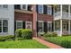Inviting brick home with black shutters, a welcoming front door, and lush landscaping at 1781 Tennyson # 6, Mount Pleasant, SC 29466