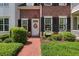 Charming home featuring a bright door with a wreath, surrounded by lush landscaping and black shutters at 1781 Tennyson # 6, Mount Pleasant, SC 29466