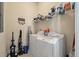 Functional laundry room with a washer, dryer, shelving, and essential cleaning supplies at 1781 Tennyson # 6, Mount Pleasant, SC 29466