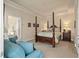 Elegant main bedroom with tray ceiling, a four poster bed, and an adjoining bathroom at 1781 Tennyson # 6, Mount Pleasant, SC 29466
