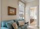 Comfortable sitting room with a blue couch, framed artwork, and access to an elegant bathroom with tub at 1781 Tennyson # 6, Mount Pleasant, SC 29466