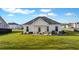 Wide view of backyard with patio, furniture, outdoor cooking equipment, and newly planted sod at 179 Darby Meadow Ln, Ridgeville, SC 29472