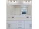 Bathroom featuring double vanity with white cabinets, large mirror, and tile flooring at 179 Darby Meadow Ln, Ridgeville, SC 29472