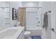 Clean, white bathroom featuring a shower-tub combo with patterned curtain and a modern vanity with sleek fixtures at 179 Darby Meadow Ln, Ridgeville, SC 29472