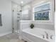 Bathroom with large soaking tub, glass shower and stained glass window at 179 Darby Meadow Ln, Ridgeville, SC 29472