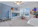 Bedroom with blue accent wall, bunk beds, carpet flooring and lots of natural light at 179 Darby Meadow Ln, Ridgeville, SC 29472