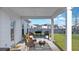 Cozy covered patio with seating, a fire pit, and a clear view of the fenced backyard at 179 Darby Meadow Ln, Ridgeville, SC 29472