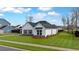 Well-maintained home featuring a lush green lawn, complemented by sleek black accents and a tidy landscape at 179 Darby Meadow Ln, Ridgeville, SC 29472