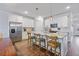 Modern kitchen with stainless steel refrigerator, granite countertops, and wooden bar stools at 179 Darby Meadow Ln, Ridgeville, SC 29472