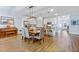 Open-concept kitchen with stainless steel appliances, a central island with granite counters, and hardwood floors at 179 Darby Meadow Ln, Ridgeville, SC 29472