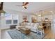 Bright open-concept living room and kitchen with hardwood floors, modern decor, and ample seating at 179 Darby Meadow Ln, Ridgeville, SC 29472