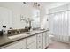 Well-lit bathroom with double sinks, grey countertops and shower over tub at 1872 Rifle Range Rd, Mount Pleasant, SC 29464