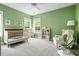Charming Bedroom with a crib, rocking chair, and soft green walls at 1872 Rifle Range Rd, Mount Pleasant, SC 29464