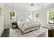 Bright and airy bedroom features a comfortable bed, stylish decor, and natural light from three windows at 1872 Rifle Range Rd, Mount Pleasant, SC 29464