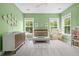Bedroom with a crib, changing table, and plenty of natural light at 1872 Rifle Range Rd, Mount Pleasant, SC 29464