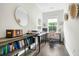 A well-lit home office with modern furniture and a large window at 1872 Rifle Range Rd, Mount Pleasant, SC 29464