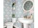 Unique powder room featuring flamingo wallpaper, stylish fixtures, and a pedestal sink for an elegant touch at 1872 Rifle Range Rd, Mount Pleasant, SC 29464