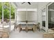 Relaxing screened porch features a dining table and chairs, providing an ideal space for outdoor meals and entertaining at 1872 Rifle Range Rd, Mount Pleasant, SC 29464