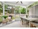 Inviting screened porch features an outdoor dining set and stylish seating area with views of the backyard at 1872 Rifle Range Rd, Mount Pleasant, SC 29464