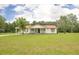 Charming home featuring a cozy front porch, complemented by a vast, well-maintained green lawn at 201 Welles Ln, Walterboro, SC 29488