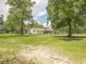 Idyllic home exterior on a expansive green lawn, surrounded by mature trees at 201 Welles Ln, Walterboro, SC 29488
