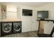 Well-lit laundry room area with a treadmill and sleek washer and dryer units at 201 Welles Ln, Walterboro, SC 29488