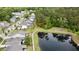 The aerial view showcases the home's setting near a pond, surrounded by mature trees at 2022 Elvington Rd, Johns Island, SC 29455