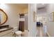 Well-lit bathroom featuring a shower-tub combo, toilet, vanity, and views to kitchen at 2022 Elvington Rd, Johns Island, SC 29455