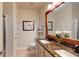 Bathroom featuring double sinks, granite countertops, and a decorative mirror at 2022 Elvington Rd, Johns Island, SC 29455