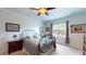 Inviting bedroom features carpet, large window, and wrought iron bed frame at 2022 Elvington Rd, Johns Island, SC 29455