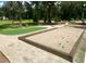 Community bocce ball court with a well-maintained putting green, offering recreational activities in a park-like setting at 2022 Elvington Rd, Johns Island, SC 29455