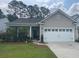 Single Gathering home featuring a two-car garage, well-maintained landscaping, and inviting front door at 2022 Elvington Rd, Johns Island, SC 29455