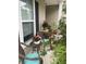 This cozy front porch features comfortable seating and colorful potted plants for a relaxed outdoor setting at 2022 Elvington Rd, Johns Island, SC 29455