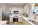 Bright kitchen with stainless appliances, white cabinets, and tile backsplash at 2022 Elvington Rd, Johns Island, SC 29455