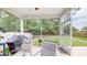Screened patio with comfortable seating, a grill, and a view of the backyard at 2022 Elvington Rd, Johns Island, SC 29455