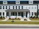 Beautiful townhome showcasing gray siding, bright white trim and a cheerful teal front door at 203 Blueway Ave, Summerville, SC 29486