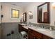 Spacious bathroom with a dual sink vanity, gray tile floors and a decorative stained glass window at 2050 Wappoo Hall Rd, Charleston, SC 29412