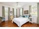 Inviting bedroom with hardwood floors, light pink walls, and three large windows that provide natural light at 2050 Wappoo Hall Rd, Charleston, SC 29412