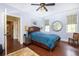 Bedroom featuring light blue walls, hardwood floors, ceiling fan, and a window to let light in at 2050 Wappoo Hall Rd, Charleston, SC 29412