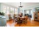Bright dining room with hardwood floors, large windows, and a stylish chandelier at 2050 Wappoo Hall Rd, Charleston, SC 29412