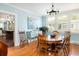 Bright dining room with hardwood floors and an adjacent view into the kitchen at 2050 Wappoo Hall Rd, Charleston, SC 29412
