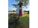 Charming windmill structure with a red door and surrounding yard, adding a unique touch to the property at 2050 Wappoo Hall Rd, Charleston, SC 29412