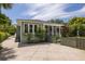 Charming home exterior with green siding, a screened in porch, and lush landscaping at 2050 Wappoo Hall Rd, Charleston, SC 29412