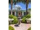 Charming home featuring a red front door, well-manicured garden, and a lovely water fountain at 2050 Wappoo Hall Rd, Charleston, SC 29412