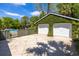 Detached two-car garage with an ivy-covered facade, next to a fenced in pool and driveway at 2050 Wappoo Hall Rd, Charleston, SC 29412