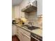 Close up of the chef's kitchen with stainless steel hood vent and granite countertops at 2050 Wappoo Hall Rd, Charleston, SC 29412