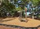 Community playground with swings and play structures set in a wooded area with shade trees at 2050 Wappoo Hall Rd, Charleston, SC 29412